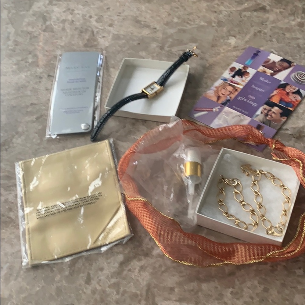 MK charm bracelets and watch with business tools.